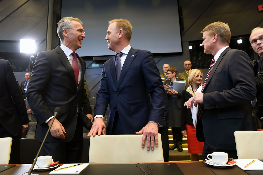 Acting Defense Secretary Patrick M. Shanahan talks with NATO Secretary General Jens Stoltenberg at NATO headquarters in Brussels.