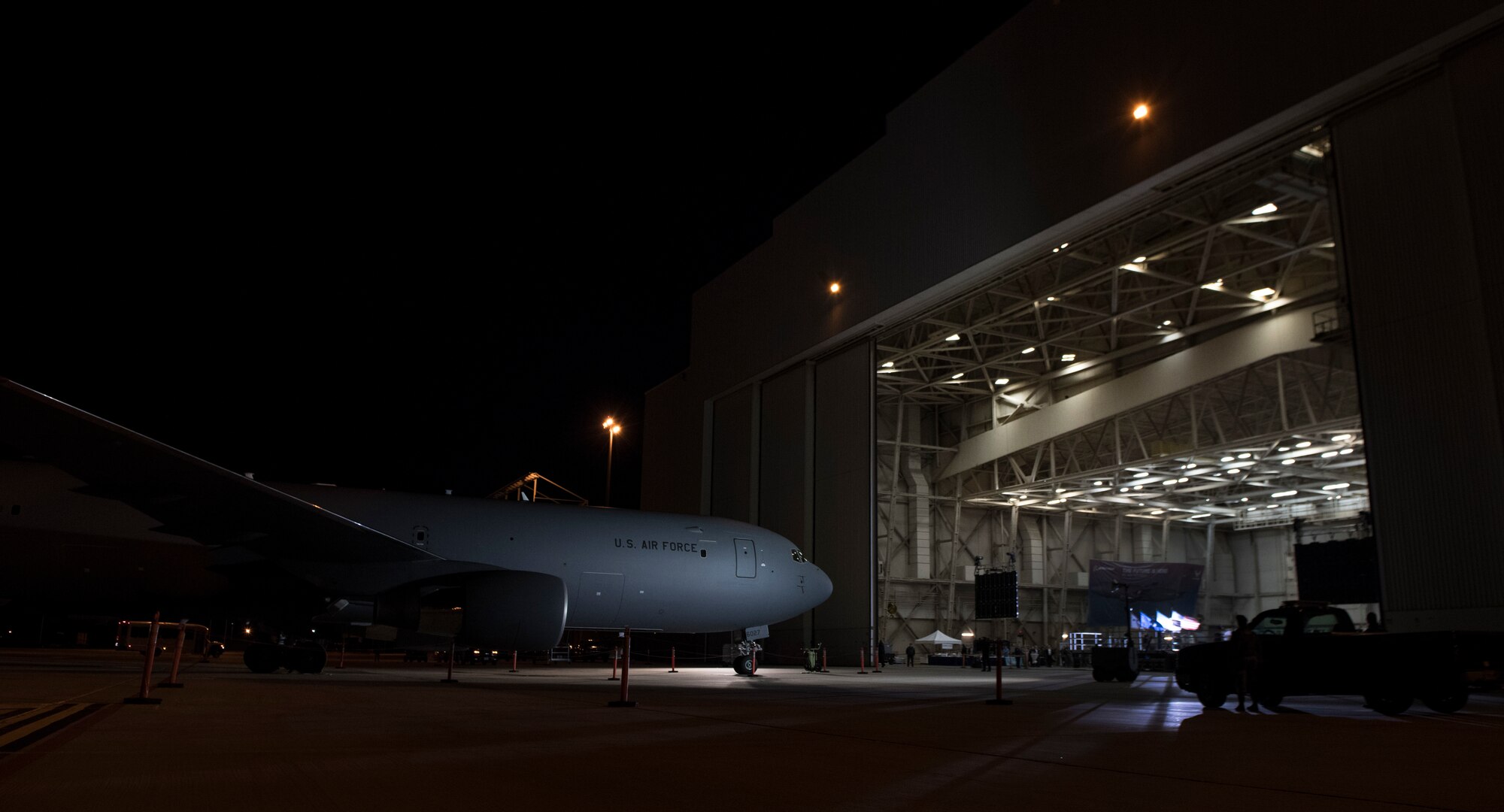 a plane in front of a hangar