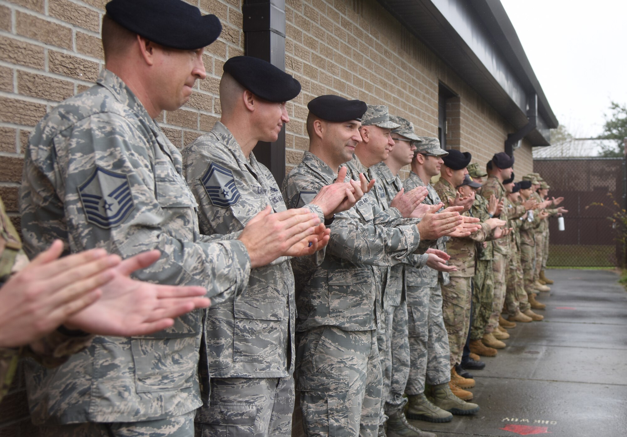 Keesler leadership and members of the 81st Security Forces Squadron applaud following a military working dog demonstration during the 81st SFS Military Working Dog Kennel Expo at Keesler Air Force Base, Mississippi, Feb. 11, 2019. The event, which is one of several in recognition of the Year Of The Defender, allowed the 81st SFS to showcase their training and mission capabilities to leadership from the 81st Training Wing. The expo included a daily MWD operations briefing, a MWD patrol scenario and a demonstration of veterinarian support provided to the MWDs. (U.S. Air Force photo by Kemberly Groue)