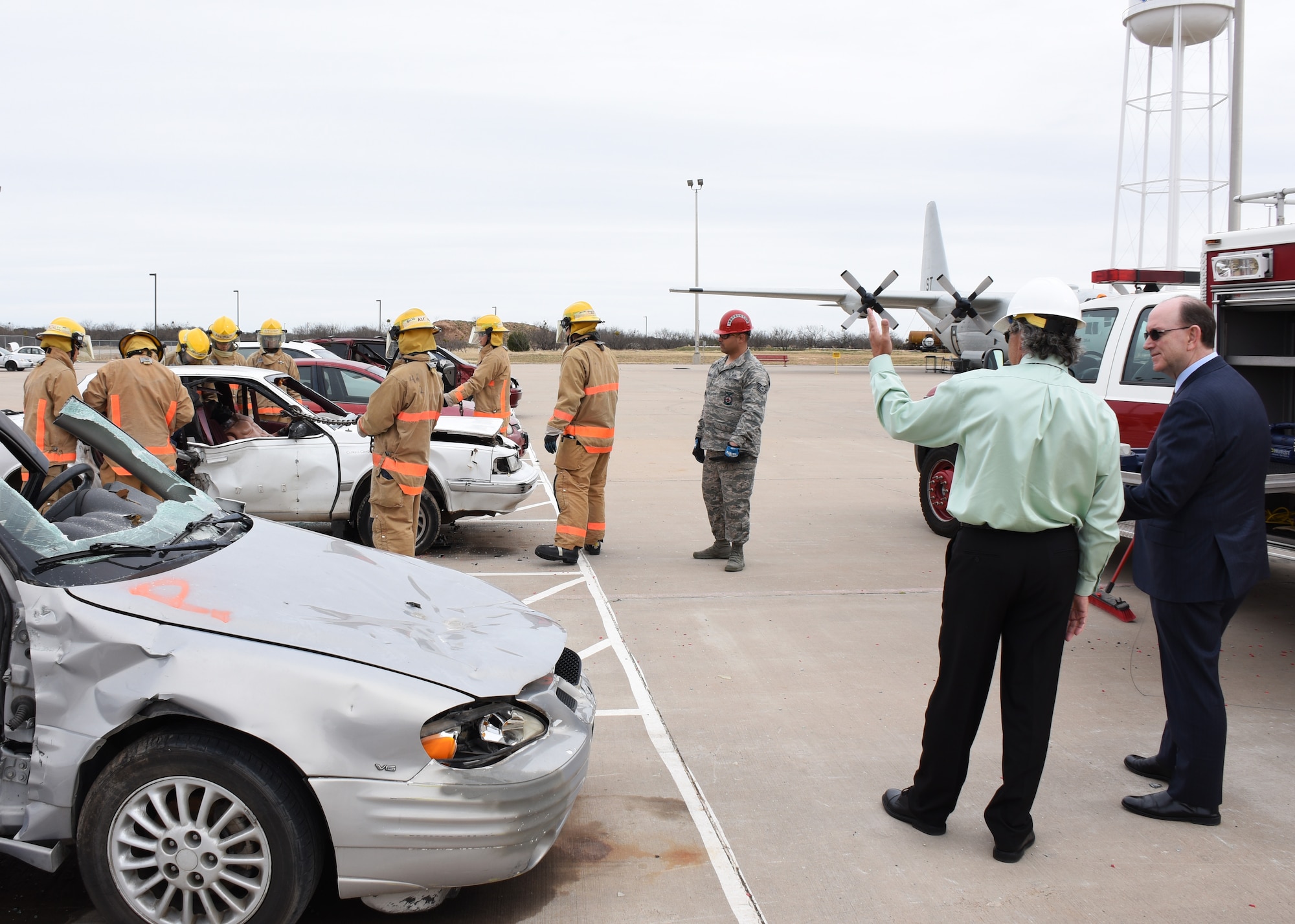 Under Secretary of the Air Force Matthew P. Donovan watches as 312th students train on vehicle entry during his tour of Goodfellow Air Force Base, Texas, Feb. 13, 2019. The 312th Training Squadron Flight Chief, Michael Dejacomo escorted Donovan around the 312th TRS fire pad where all Department of Defense firefighters train. (U.S. Air Force photo by Airman 1st Class Zachary Chapman/Released)