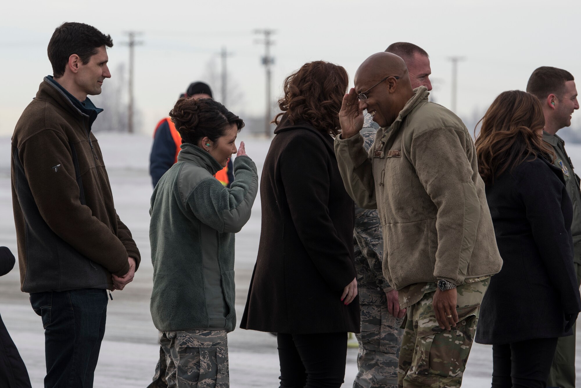 U.S. Air Force Gen. CQ Brown, Jr., Pacific Air Forces (PACAF) commander, exchanges a salute with Col. Patricia Csànk, Joint Base Elmendorf-Richardson (JBER) and 673d Air Base Wing commander, following his arrival at JBER, Alaska, Feb. 11, 2019. Brown visited JBER to meet with Airmen and to emphasize operational readiness. PACAF leadership toured various facilities throughout the installation to include the air traffic control tower, 517th Airlift Squadron and 962nd Airborne Air Control Squadron.