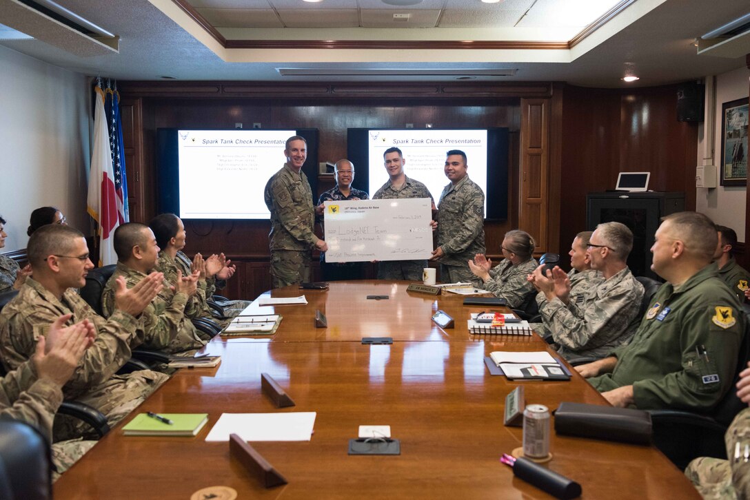 U.S. Air Force Brig. Gen. Case A. Cunningham, 18th Wing commander, presents a check for $2,500 to the 2018 Shogun Spark Tank winners for their contingency lodging application, LodgeNET, on Feb. 11, 2019 at Kadena Air Base, Japan. Innovative incentive programs such as the 18th WG Spark Tank encourage Airmen to think outside the box and provide new solutions to everyday problems.