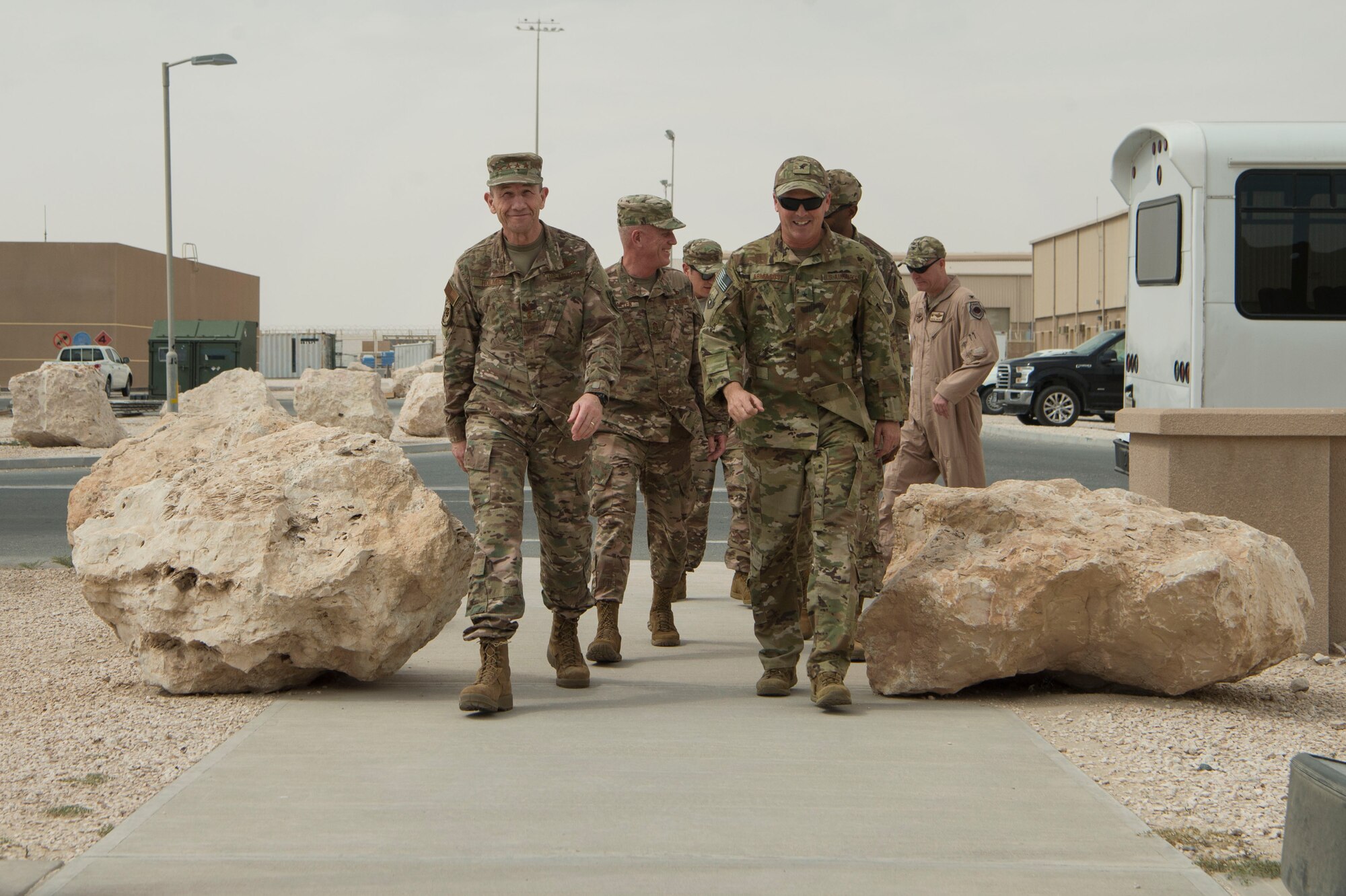 U.S. Gen. Mike Holmes, commander of Air Combat Command, and Brig. Gen. Jason Armagost, 379th Air Expeditionary Wing commander, walk to the 379th AEW Wing Operations Center during a visit from ACC leadership Feb. 11, 2019, at Al Udeid Air Base, Qatar.