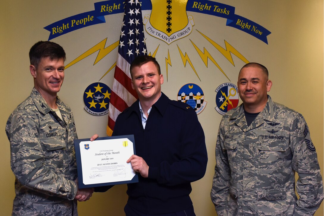 U.S. Air Force Col. Thomas Coakley, 17th Training Group commander, presents the 315th Training Squadron Officer Student of the Month award to 2nd. Lt. Austin Dobbs, 315th TRS student, at the Brandenburg Hall on Goodfellow Air Force Base, Texas, Feb. 8, 2019. The 315th TRS’s vision is to develop combat-ready intelligence, surveillance and reconnaissance professionals and promote an innovative squadron culture and identity unmatched across the U.S. Air Force. (U.S. Air Force photo by Airman 1st Class Zachary Chapman/Released)