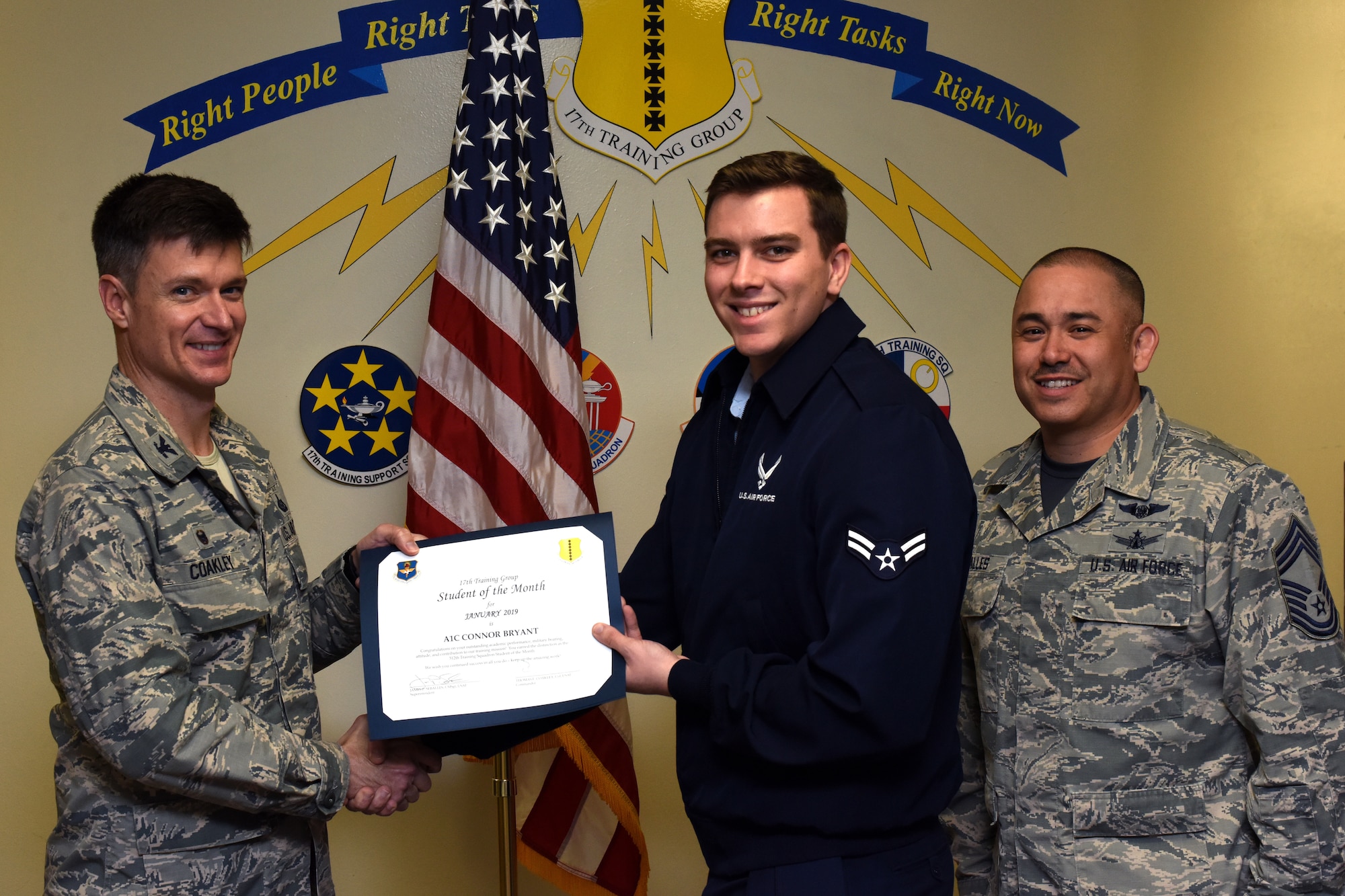 U.S. Air Force Col. Thomas Coakley, 17th Training Group commander, presents the 312th Training Squadron Student of the Month award to Airman 1st Class Connor Bryant, 312th TRS student, at the Brandenburg Hall on Goodfellow Air Force Base, Texas, Feb. 8, 2019. The 312th TRS’s mission is to provide Department of Defense and international customers with mission ready fire protection and special instruments graduates and provide mission support for the Air Force Technical Applications Center. (U.S. Air Force photo by Airman 1st Class Zachary Chapman/Released)