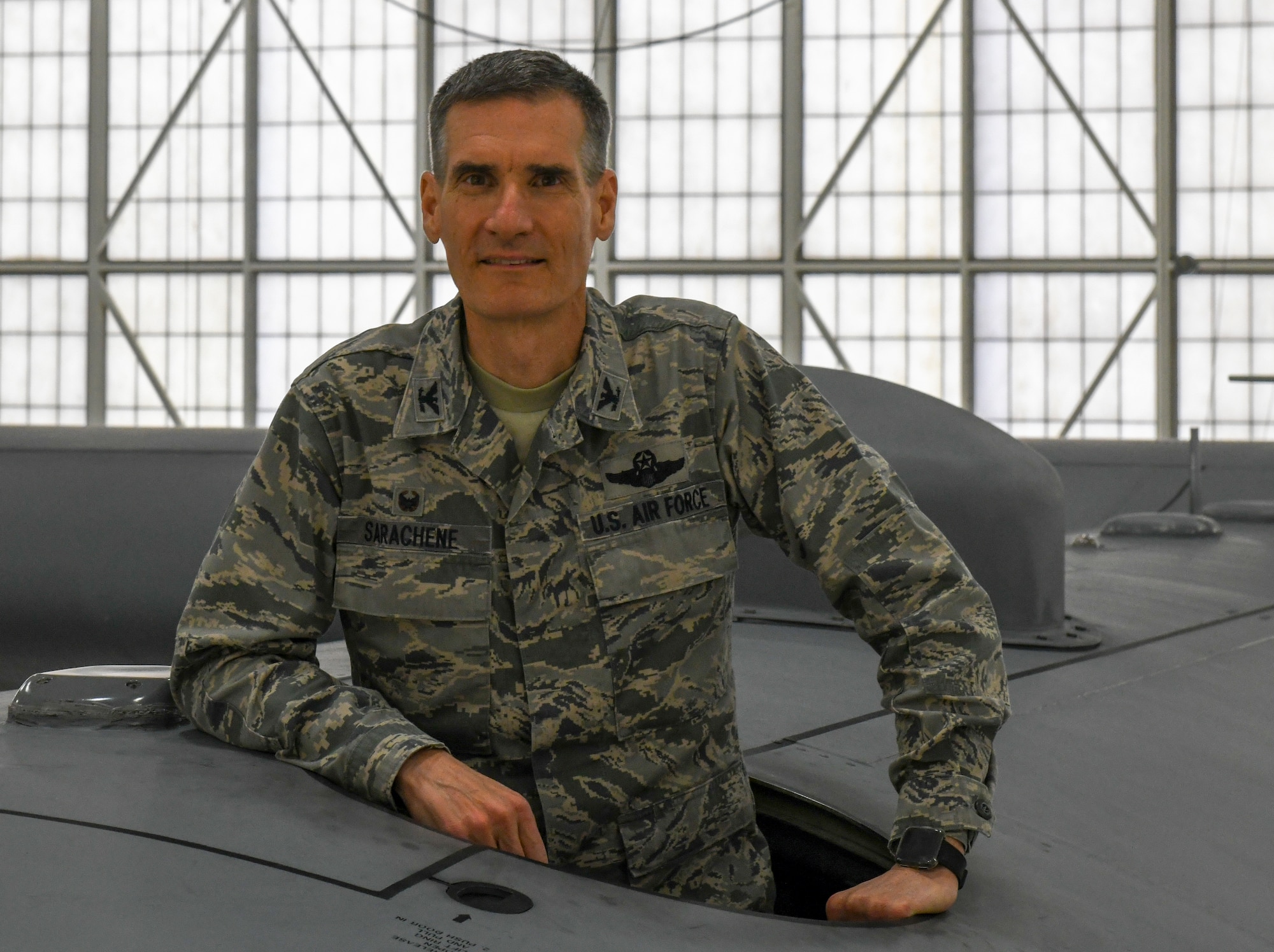 Col. Dan Sarachene, former 910th Airlift Wing commander, poses on top of a C-130H Hercules aircraft in Hangar 305 at Youngstown Air Reserve Station, Feb. 8, 2019.