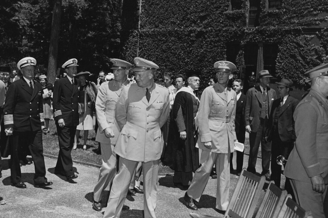 Several military dignitaries walk together after a ceremony.