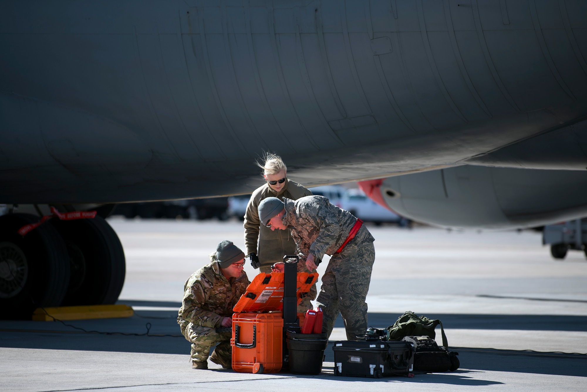 U.S. Air Force Staff Sgt. Lance McFarland, a 6th Maintenance Squadron crew chief, MacDill Air Force Base, Fla., Senior Airman Lauren Nolan, a 22nd Logistics Readiness Squadron supply technician, and Staff Sgt. Stephen Marstall, a hydraulics craftsman with the 22nd Maintenance Squadron, McConnell AFB, Kan., gather tools to maintain a KC-135 Stratotanker aircraft during exercise Red Flag 19-1, at Nellis AFB, Nev., Feb. 6, 2019. More than 2,900 personnel from the U.S. Air Force, U.S. Navy, Royal Air Force and Royal Australian Air Force participated in the realistic training exercise designed to enhance combat readiness and survivability.  (U.S. Air Force photo by Senior Airman Ashley Perdue)