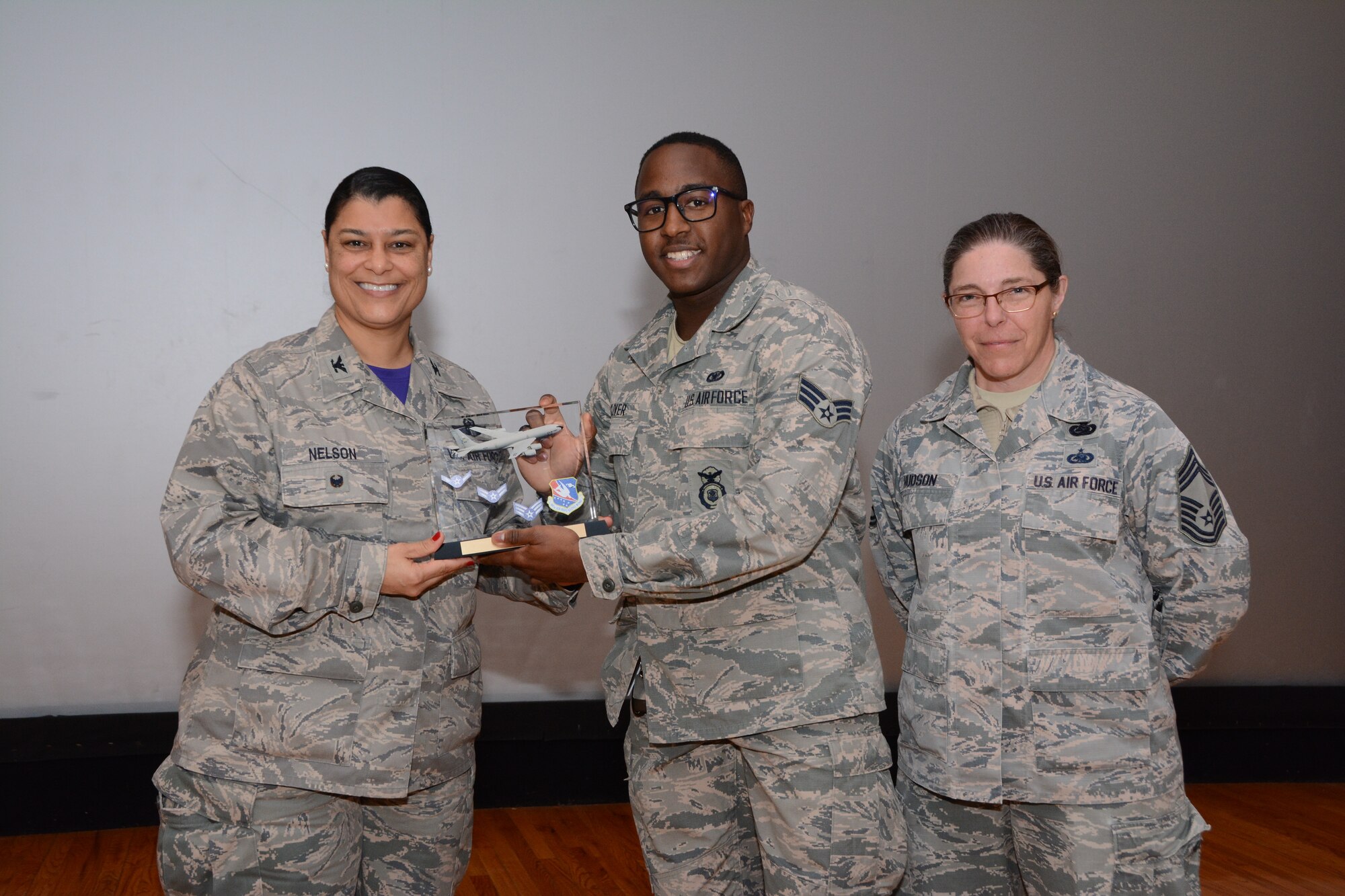 Col. Dana Nelson, 507th Air Refueling Wing Vice Commander, and Chief Master Sgt. Julie Hudson, 507th Mission Support Group superintendent, present the Airman of the 4th Quarter 2018 Award to Senior Airman Shannon Glover, 507th Security Forces Squadron, Feb. 10, 2019, at Tinker Air Force Base, Oklahoma. (U.S. Air Force photo by Tech. Sgt. Samantha Mathison)