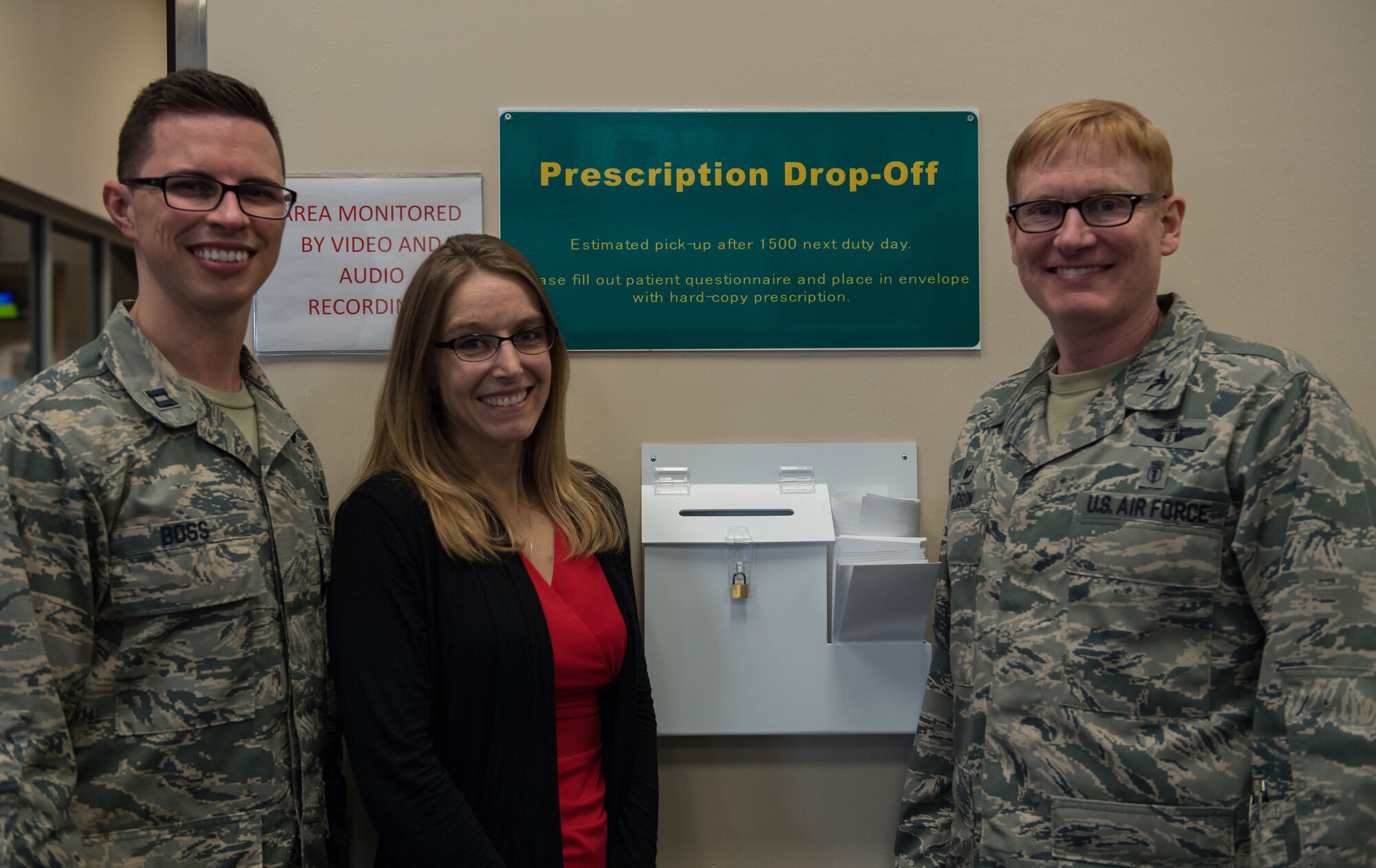Capt. Angelo Boss, left, 2nd Medical Group Satellite Pharmacy’s element chief, Monica Miller, center, key spouse, and Col. Christopher Hudson, right, 2nd MDG commander, pose for a photo in front of a prescription drop box at Barksdale Air Force Base, La., Feb. 4, 2019. There are three drop boxes, one at the entrance, the lobby and the second drive-thru lane at the satellite pharmacy.  (U.S. Air Force photo by Senior Airman Cassandra Johnson)
