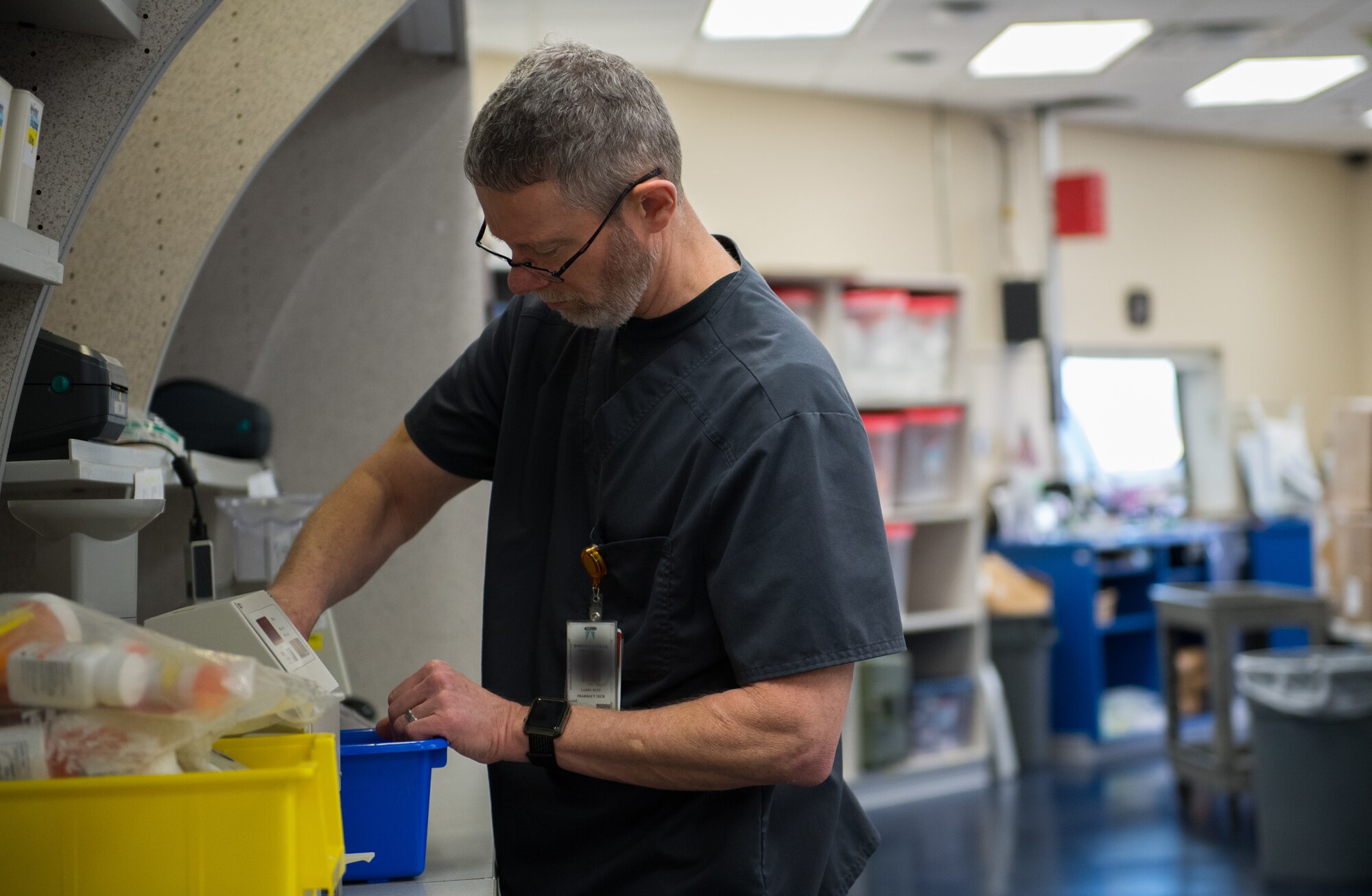 Larry Rusk, 2nd Medical Group Satellite Pharmacy technician, prepares medications at Barksdale Air Force Base, La., Feb. 5, 2019. The pharmacy process 300 to 400 new prescriptions every day. This photo has been altered for security purposes. (U.S. Air Force photo by Senior Airman Cassandra Johnson)