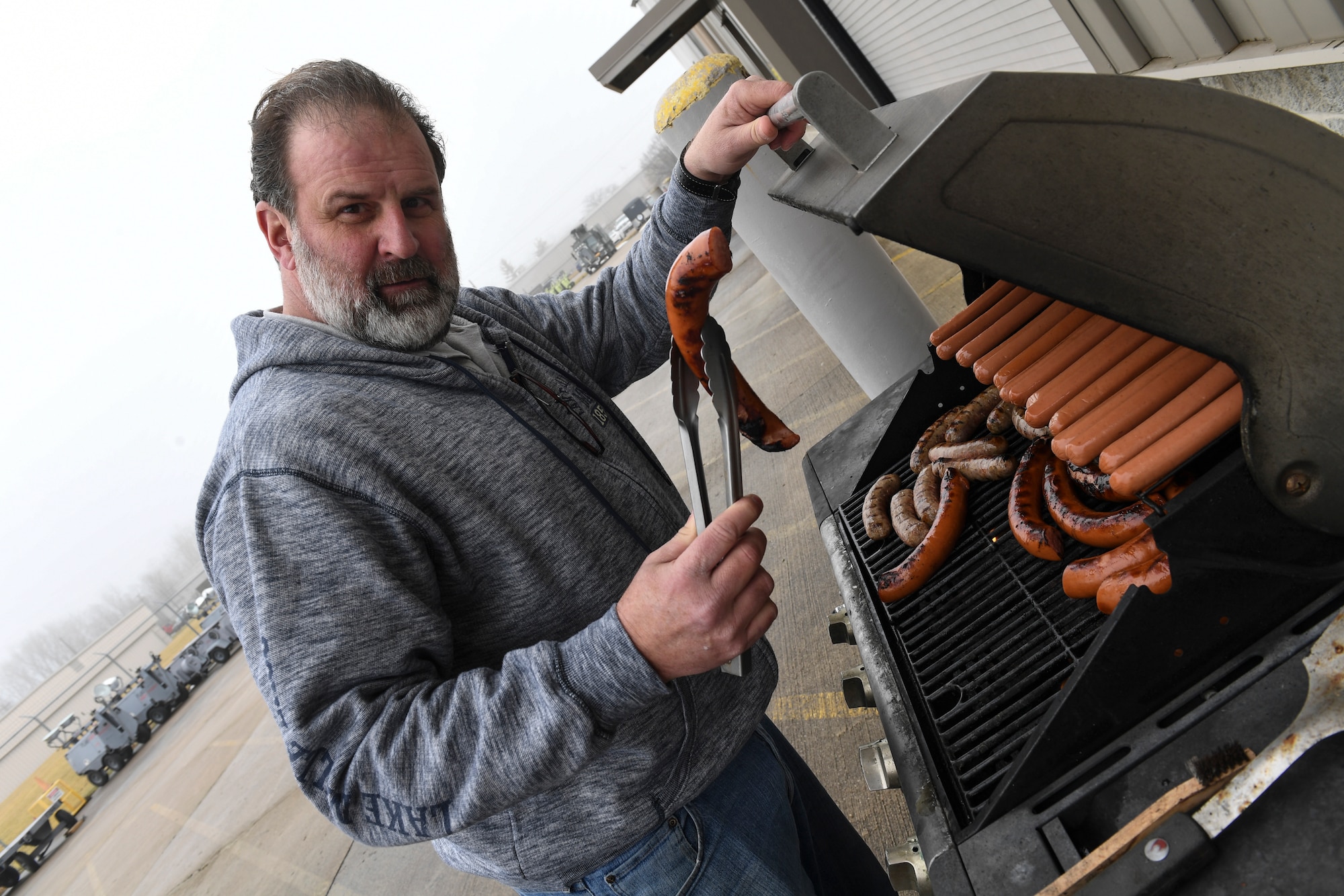 Richard Oram, occupational safety manager with the 911th Airlift Wing Safety Office, shows off his grilling skills while preparing a home-cooked meal for members of the 911th Maintenance Group who are on a temporary duty assignment at Wright-Patterson Air Force Base, Ohio, Feb. 5, 2019. The meal was prepared on behalf of the group leadership and the Key Spouse Organization in appreciation of the tireless dedication the members have shown while being away from loved ones while they work away from home. (U.S. Air Force photo by Joshua J. Seybert)