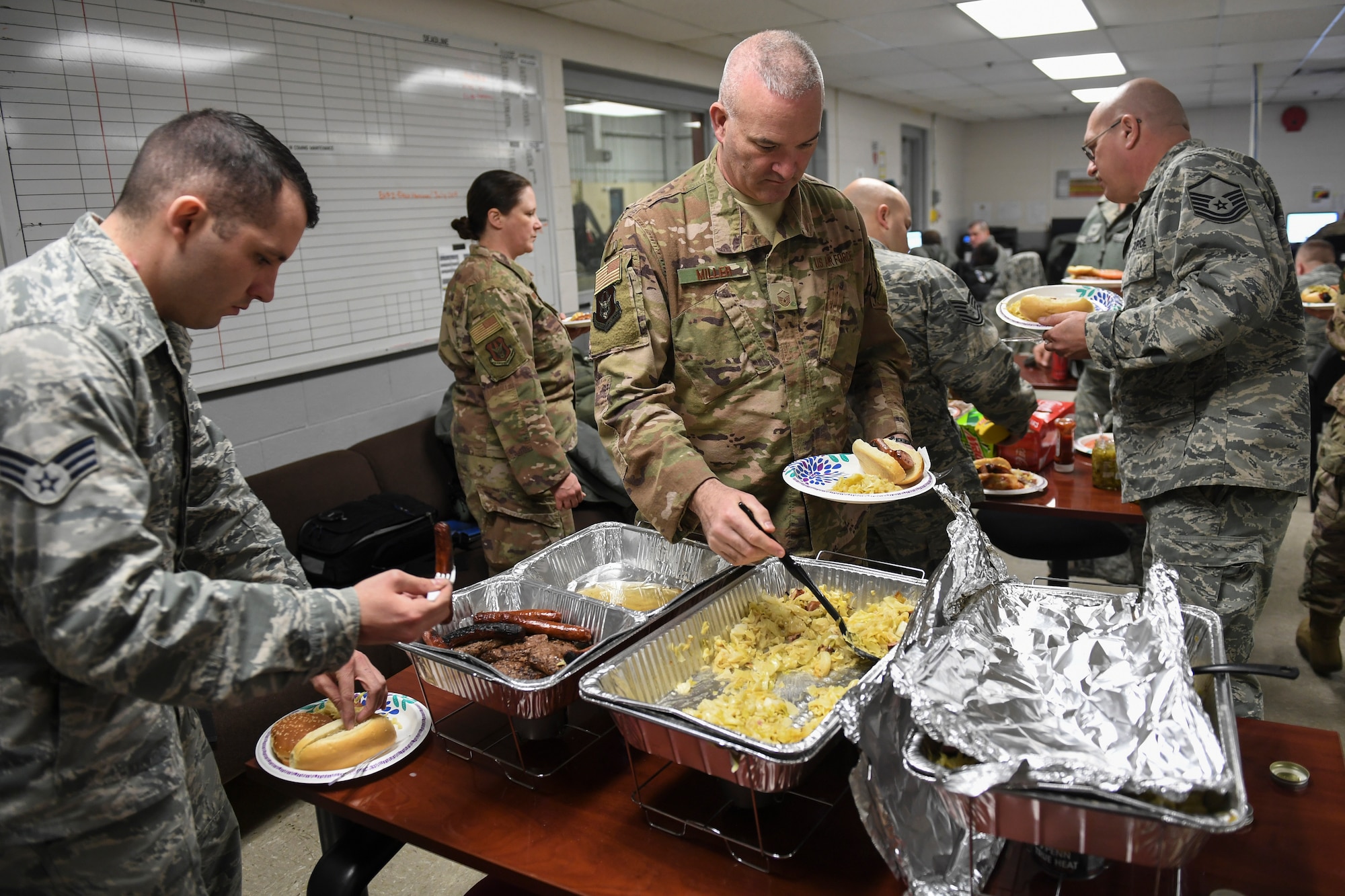 Members of the 911th Maintenance Group help themselves to a home-cooked meal prepared by members of the 911th Airlift Wing Safety Office at Wright-Patterson Air Force Base, Ohio, Feb. 5, 2019. The meal was prepared on behalf of the group leadership and the Key Spouse Organization in appreciation of the tireless dedication the members have shown while being away from loved ones while they work away from home. (U.S. Air Force photo by Joshua J. Seybert)