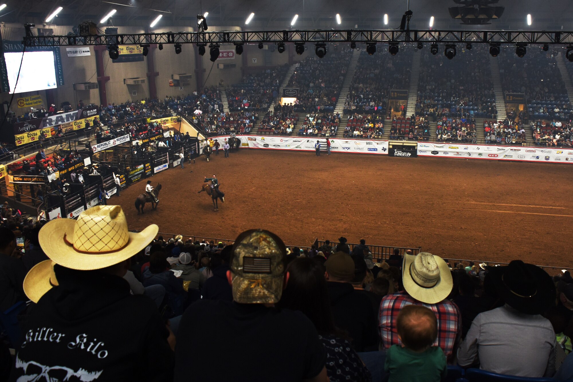 The San Angelo Stock Show and Rodeo Ambassadors Drill Team perform during the Annual San Angelo Stock Show and Rodeo Military Appreciation Night at the Foster Communications Coliseum in San Angelo, Texas, Feb. 13, 2019. They carried patriotic flags during the drill. (U.S. Air Force photo by Airman 1st Class Zachary Chapman/Released)