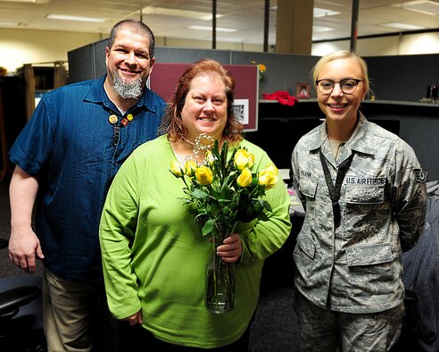 A.J. Murphy, Jeanann Murphy, and Staff Sgt. Shayna Frank pose for a photo at the National Air and Space Intelligence Center, Feb. 14. Murphy and Frank delivered flowers as part of a fundraiser for NASICs Chief’s Group.  Valentine’s Day is just one day a year; The Center’s R3 leaders ask Airmen at all levels to focus on strengthening relationships year-long. (U.S. Air Force photo by Senior Airman Michael Hunsaker)