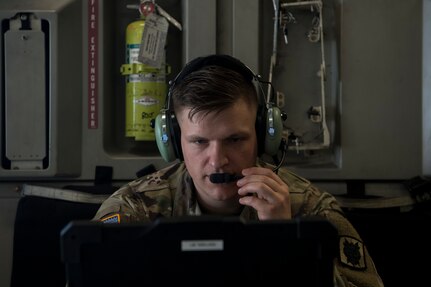 Army Capt. Corey Gunderson, 50th Expeditionary Signal Battalion Delta Company commander, tests the in-flight communications system in a C-17 Globemaster III after a team finished their certification training Feb. 7, 2019 at Joint Base Charleston, S.C.