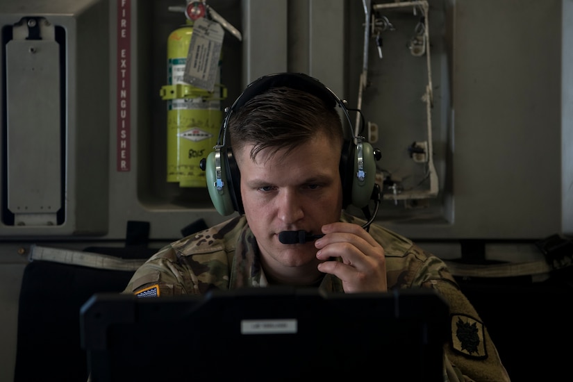 Army Capt. Corey Gunderson, 50th Expeditionary Signal Battalion Delta Company commander, tests the in-flight communications system in a C-17 Globemaster III after a team finished their certification training Feb. 7, 2019 at Joint Base Charleston, S.C.