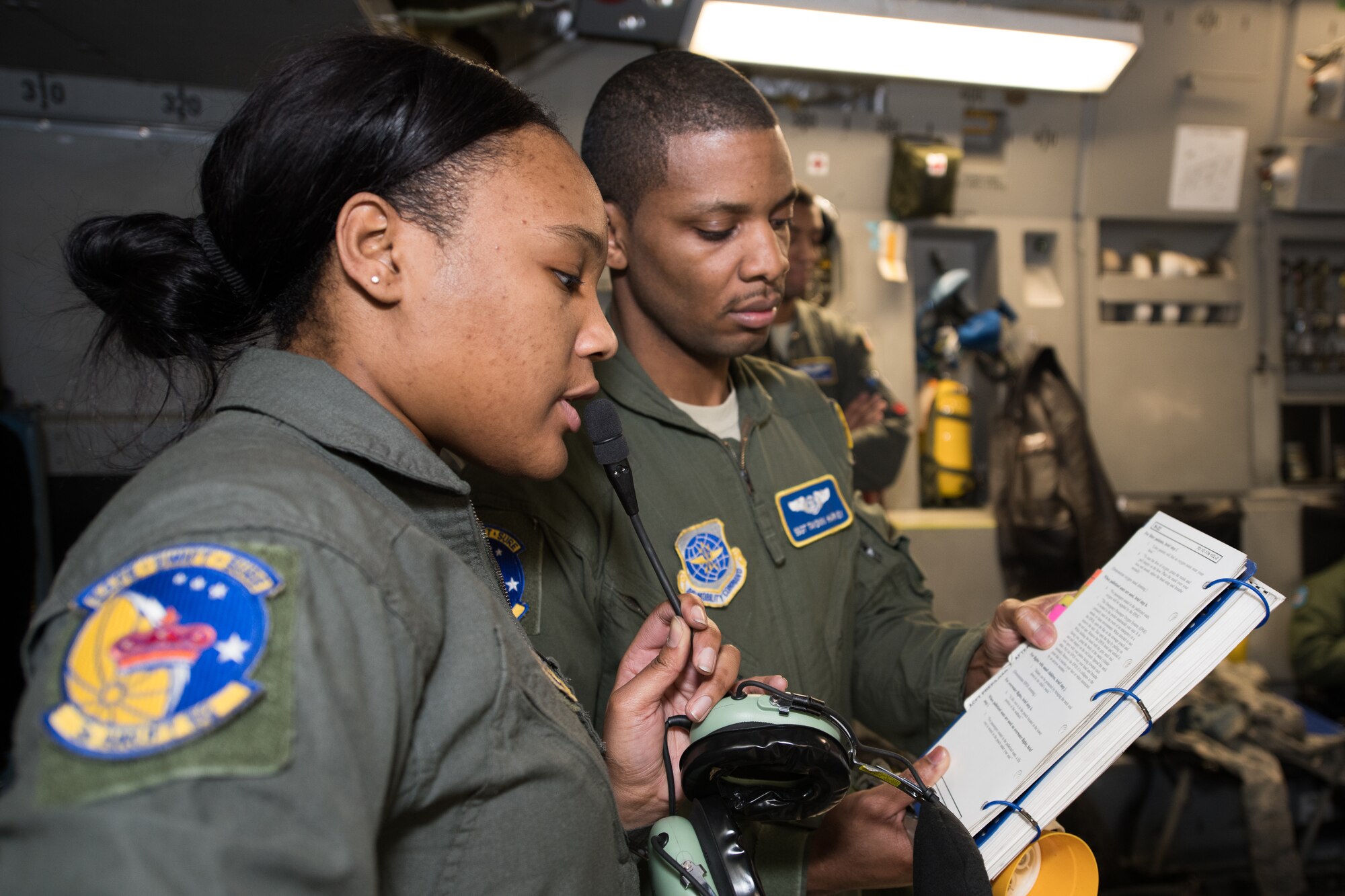 Airman 1st Class Shanteisha Gordon and Staff Sgt. Tayonn Harvey, 3rd Airlift Squadron C-17 loadmasters, give a passenger briefing to a group of ROTC and JROTC cadets  Feb. 12, 2019, at Dover Air Force Base, Delaware. The crew made themselves available during the flight to answer questions about education requirements, technical schools and other aspects of military life (U.S. Air Force photo by Mauricio Campino)