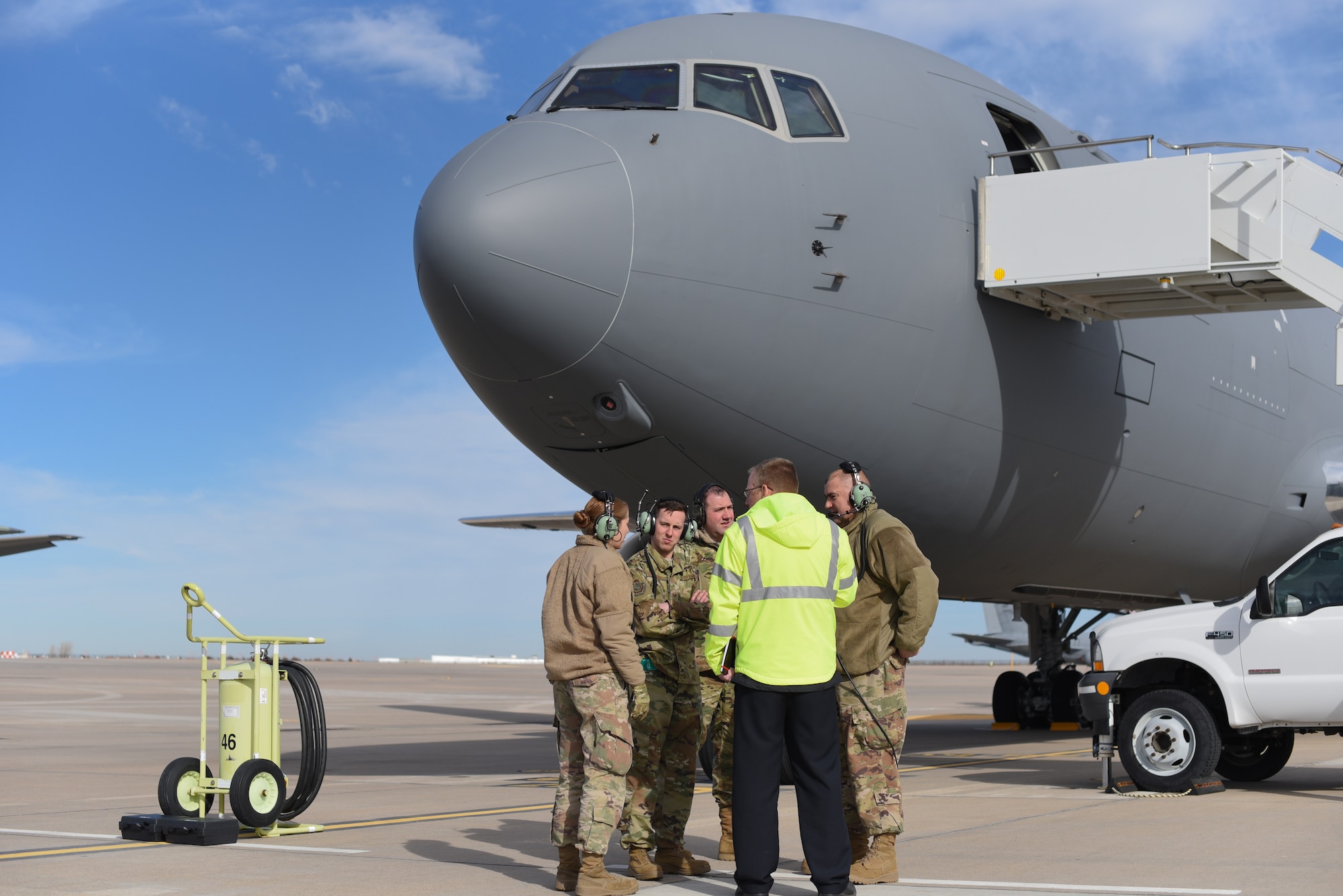 Members of the 22nd Maintenance Group discuss engine start procedures Feb. 14, 2019, at McConnell Air Force Base, Kan. The KC-46A Pegasus will serve alongside the KC-135 Stratotanker supplying critical aerial refueling, airlift and aeromedical evacuation capabilities for America's military and its allies. (U.S. Air Force photo by Airman 1st Class Alexi Myrick)