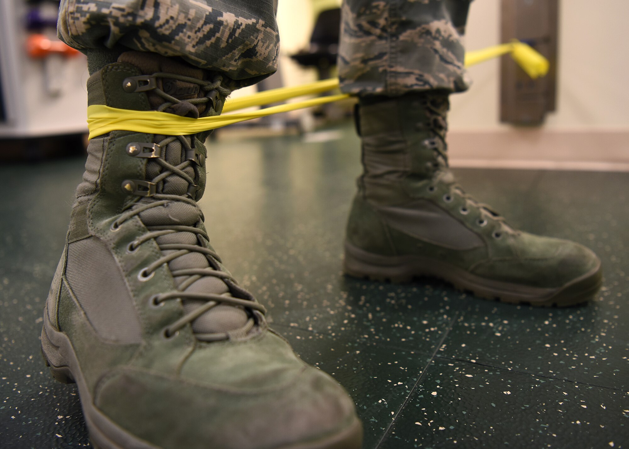 A U.S. Air Force Airman performs a physical therapy exercise with an elastic band at Osan Air Base, Republic of Korea, Feb. 12, 2019. The 51st Medical Operations Squadron physical therapy office implemented a post-flight checklist to minimize the effects of flying. This includes aiding recovery for pilots due to the prolonged sitting while flying aircraft and dealing with gravitational forces from maneuvers. (U.S. Air Force photo by Staff Sgt. Sergio A. Gamboa)
