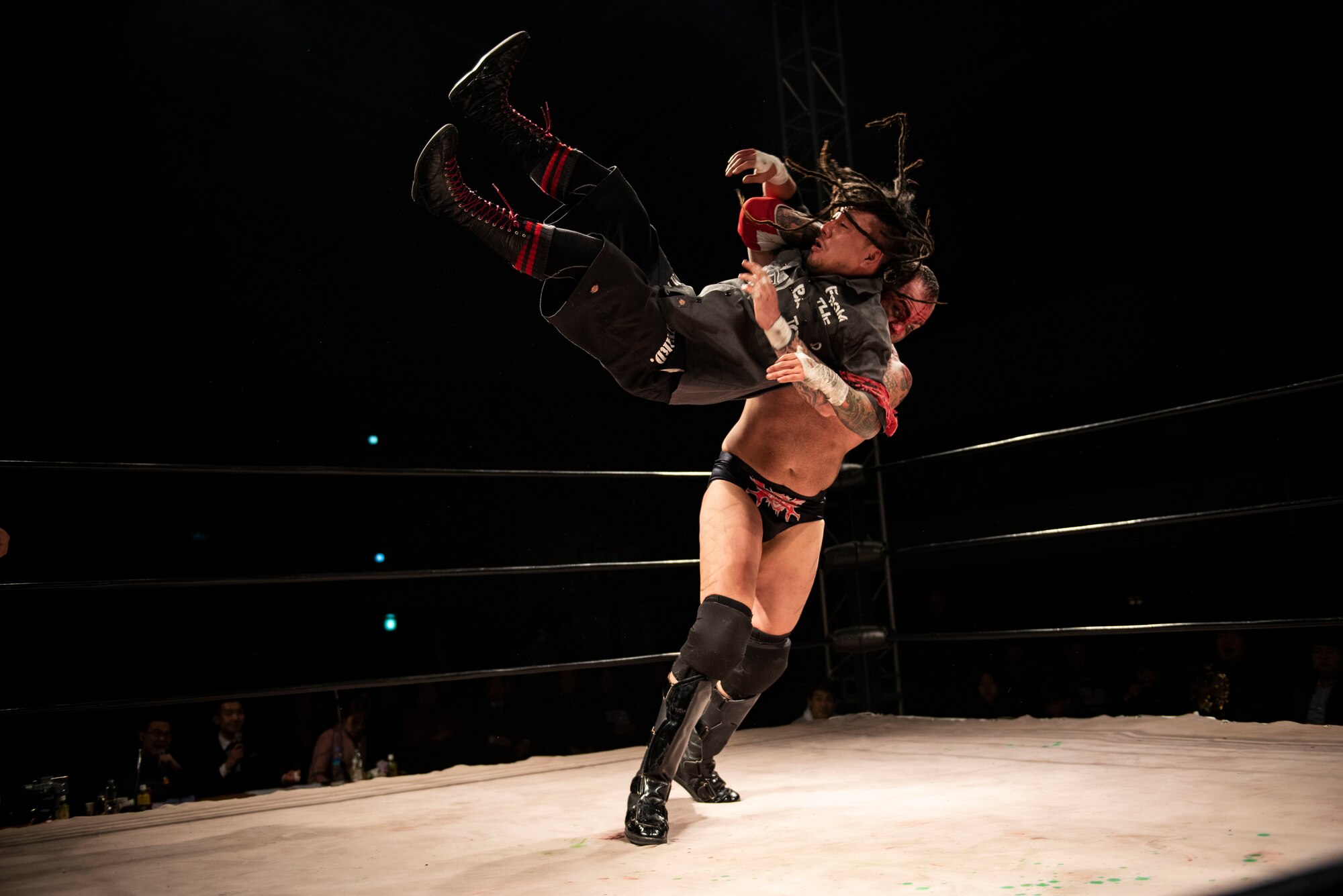 U.S. Air Force Tech. Sgt. Gregory Gauntt, 8th Logistics Readiness Squadron non-commissioned officer in charge of fuels knowledge operations, power slams his opponent during a wrestling match at Pyeongtaek, Republic of Korea, Feb. 9, 2019. Gauntt goes by the name Ryan Oshun for professional wrestling and is currently one of two heavyweight champions on the Korean Peninsula. (U.S. Air Force photo by Senior Airman Stefan Alvarez)