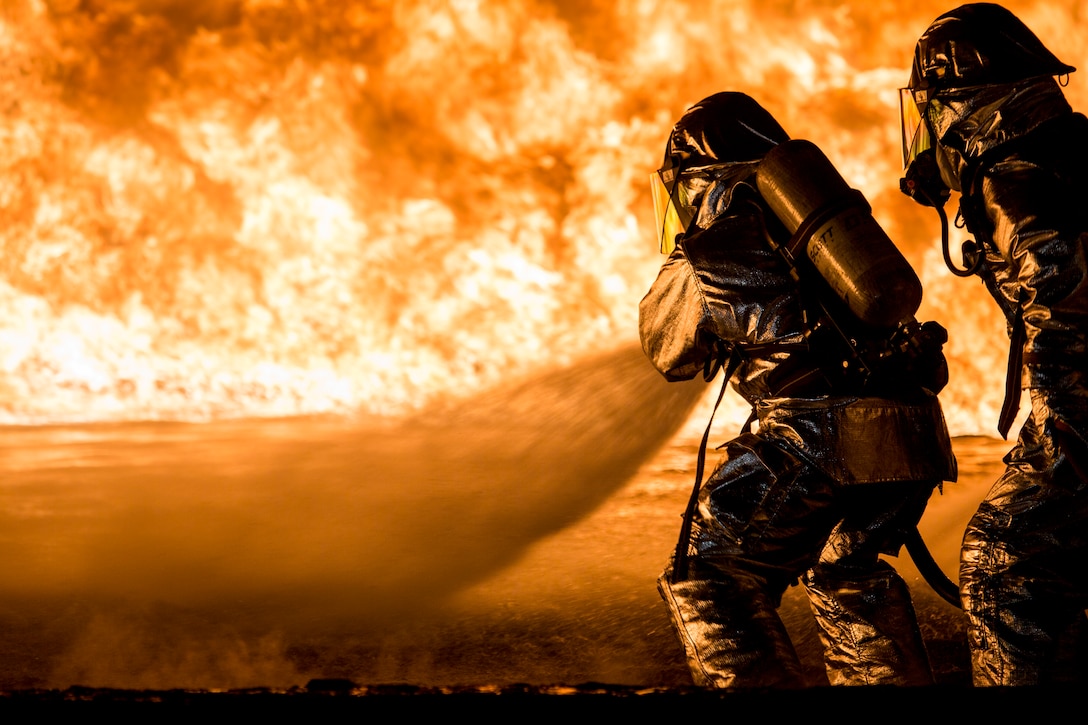 U.S. Marines with Aircraft Rescue and Firefighting (ARFF) use a hand line to extinguish a fuel fire Jan. 25, 2019 during live-burn training on Marine Corps Air Station Futenma, Okinawa, Japan. The training is held monthly to provide ARFF Marines with training scenarios to enhance their readiness to respond to any potential hazards or emergencies on the flight line. ARFF Marines entered the training area and used various hand lines, also known as a fire hose, to control and extinguish the fire. (U.S. Marine Corps photo by Lance Cpl. Nicole Rogge)