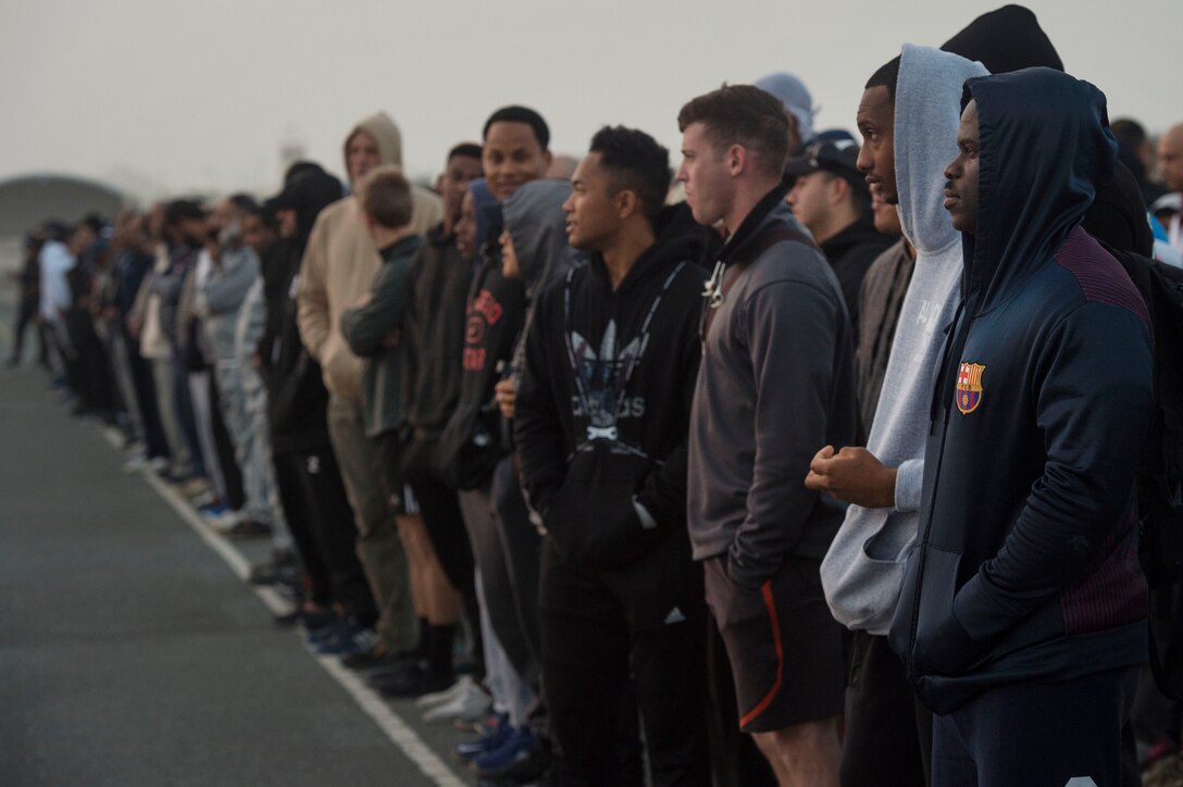U.S., Qatar, and other coalition forces line up before a group run during Qatari National Sports Day Feb. 12, 2019, at Al Udeid Air Base, Qatar. U.S. and Qatar military forces were able to compete in team events including basketball, volleyball and soccer, as well as individual events such as swimming and ping pong throughout the morning. Qatari National Sports Day provided servicemembers from both nations an opportunity to strengthen military relations through friendly competition. (U.S. Air Force photo by Tech. Sgt. Christopher Hubenthal)