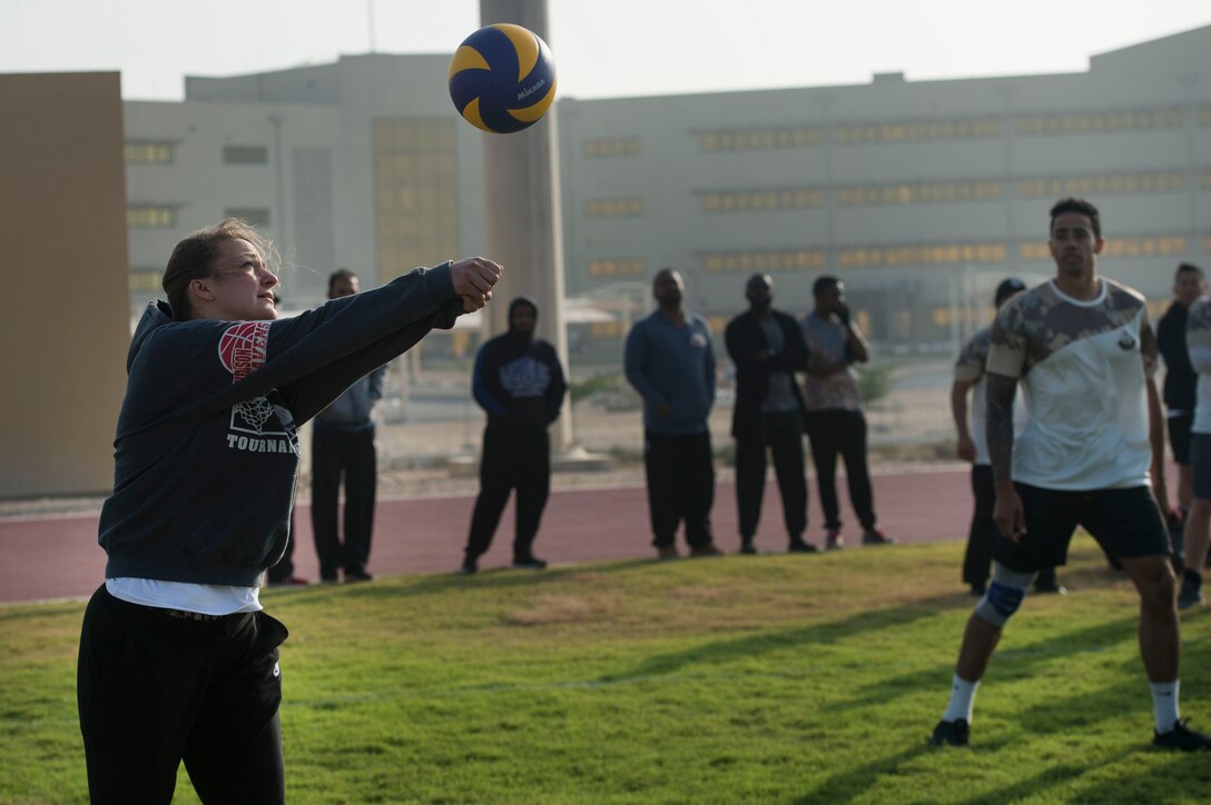 U.S. Air Force Capt. Erica Olson, 379th Air Expeditionary Wing, passes a volleyball to her teammates during a volleyball game as part of Qatari National Sports Day Feb. 12, 2019, at Al Udeid Air Base, Qatar. U.S. and Qatar military forces were able to compete in team events including basketball, volleyball and soccer, as well as individual events such as swimming and ping pong throughout the morning. Qatari National Sports Day provided servicemembers from both nations an opportunity to strengthen military relations through friendly competition. (U.S. Air Force photo by Tech. Sgt. Christopher Hubenthal)
