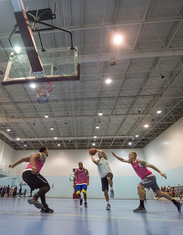 U.S. service members play a game of basketball during Qatari National Sports Day Feb. 12, 2019, at Al Udeid Air Base, Qatar. U.S. and Qatar military forces were able to compete in team events including basketball, volleyball and soccer, as well as individual events such as swimming and ping pong throughout the morning. Qatari National Sports Day provided servicemembers from both nations an opportunity to strengthen military relations through friendly competition. (U.S. Air Force photo by Tech. Sgt. Christopher Hubenthal)