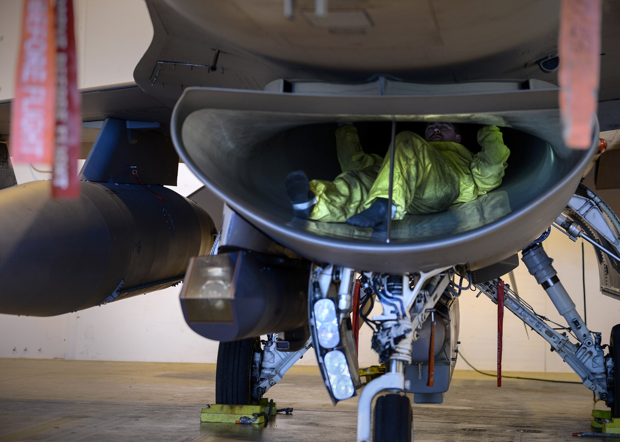 U.S. Air Force Senior Airman Jaxson Ferree, 31st Aircraft Maintenance Squadron crew chief, performs an internal inspection of an F-16 Fighting Falcon during a readiness exercise at Aviano Air Base, Italy, Feb. 11, 2019. Readiness inspections are conducted before and after each flight to ensure there is no damage to internal components of aircraft. (U.S. Air Force photo by Staff Sgt. Rebeccah Woodrow)