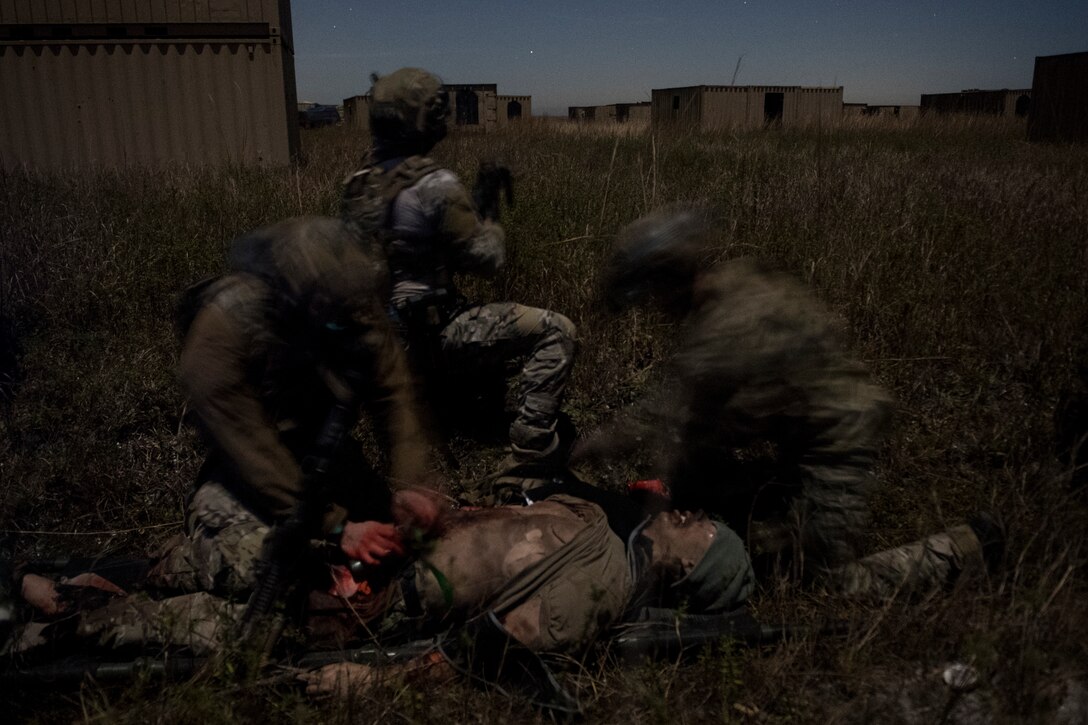 Airmen treat a simulated improvised explosive device blast patient during training