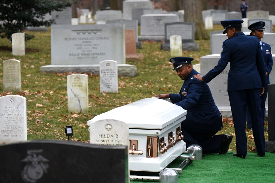 U.S. Air Force Maj. Gen. (Ret.) Marcelite Harris’ son Lt. Col. Steven Harris kneels at his mother’s gravesite after her full honors funeral