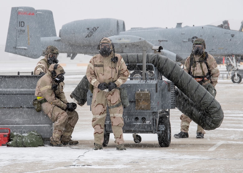 Crew chiefs wait for an A-10 Thunderbolt in the snow