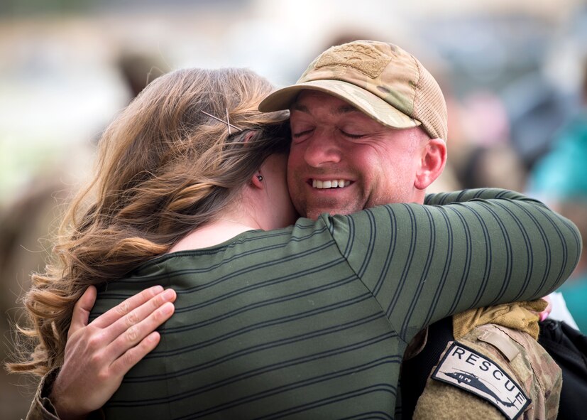 An Airman embraces his spouse during a redeployment ceremony