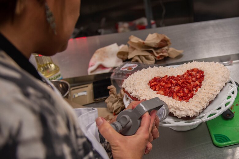 Heidi Williams, a contestant, puts frosting on her cake during the first Cupid Cake Wars, Feb. 13, 2019, at Moody Air Force Base, Ga. The event consisted of contestants working together in teams to create, bake and design their most inspired Valentine’s Day-themed cakes. (U.S. Air Force Photo by Airman 1st Class Joseph P. Leveille)
