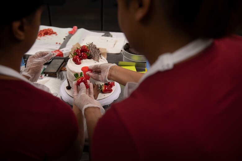 Janice Johnson, left, and her sister Jessica, contestants, decorate a cake during the first Cupid Cake Wars, Feb. 13, 2019, at Moody Air Force Base, Ga. The event consisted of contestants working together in teams to create, bake and design their most inspired Valentine’s Day-themed cakes. (U.S. Air Force Photo by Airman 1st Class Joseph P. Leveille)