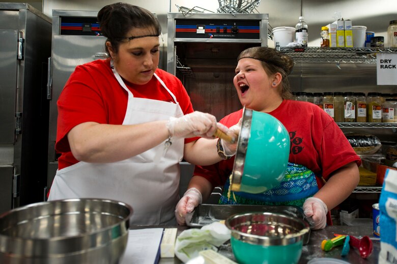 Heather Brooks, left, and her daughter Laila, contestants, pour cake batter into a pan during the first Cupid Cake Wars, Feb. 13, 2019, at Moody Air Force Base, Ga. The event consisted of contestants working together in teams to create, bake and design their most inspired Valentine’s Day-themed cakes. (U.S. Air Force photo by Airman 1st Class Erick Requadt)