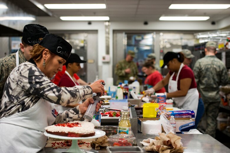 Contestants work on their cakes during the first Cupid Cake Wars, Feb. 13, 2019, at Moody Air Force Base, Ga. The event consisted of contestants working together in teams to create, bake and design their most inspired Valentine’s Day-themed cakes. (U.S. Air Force photo by Airman 1st Class Erick Requadt)