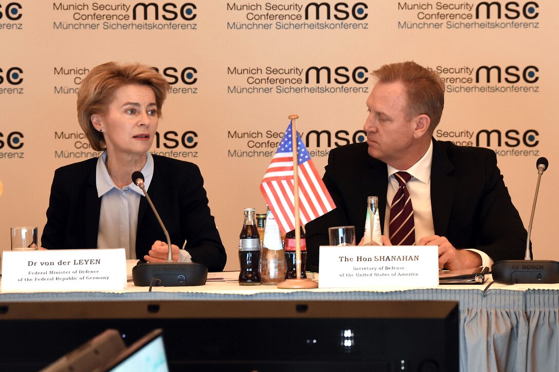 Two defense leaders speak during a security conference,
