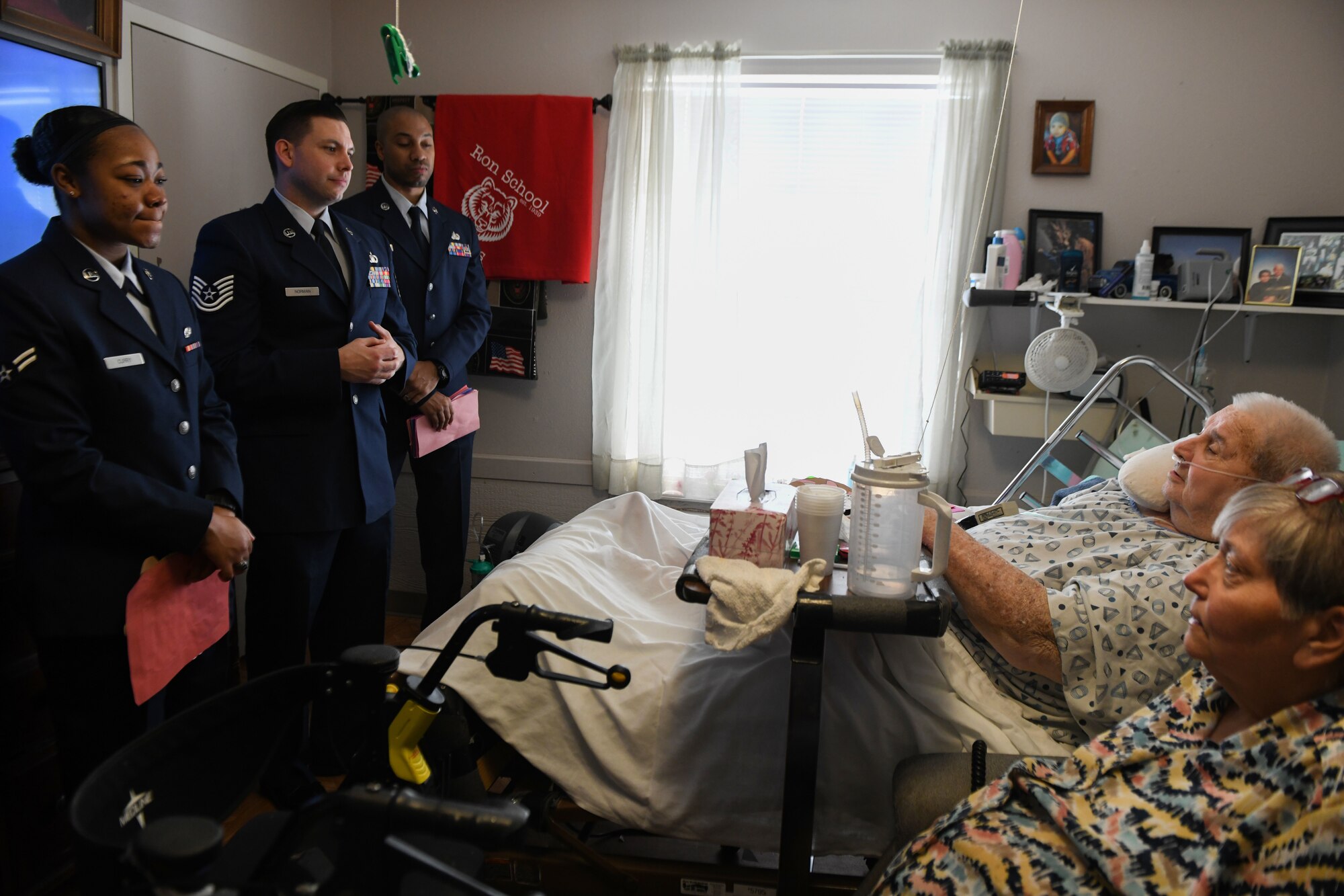 Airmen assigned to the 97th Air Mobility Wing talk with two veterans after giving them Valentine’s Day cards