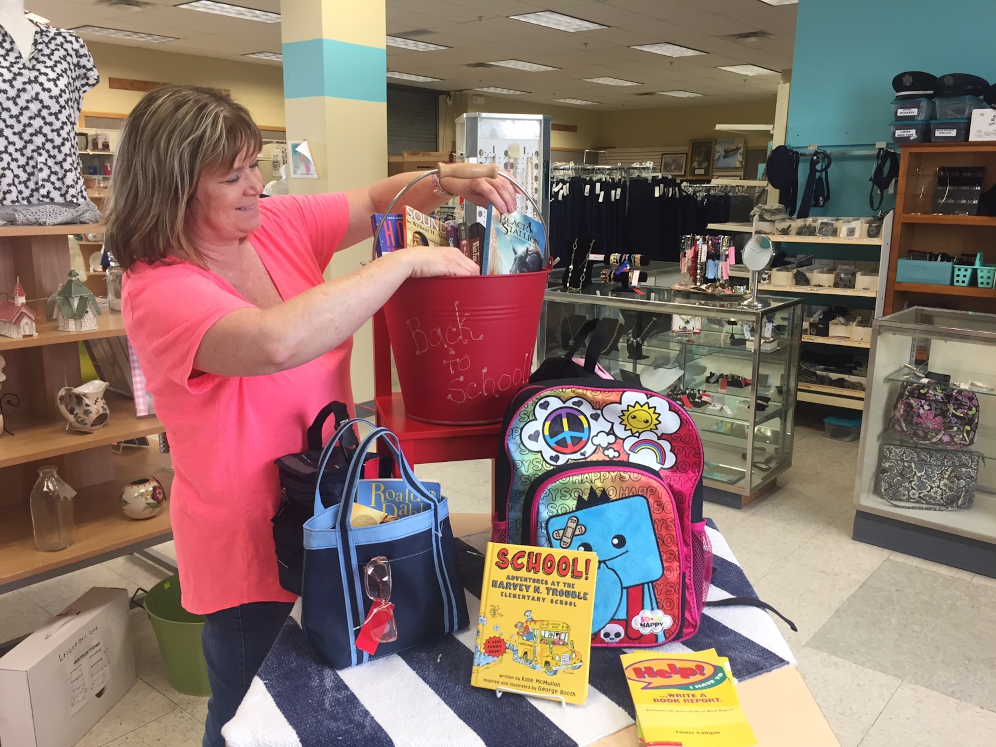 Wright-Patterson Air Force Base Thrift Shop Manager Paula Cardenas prepares a display. (Skywrighter photo/Amy Rollins)