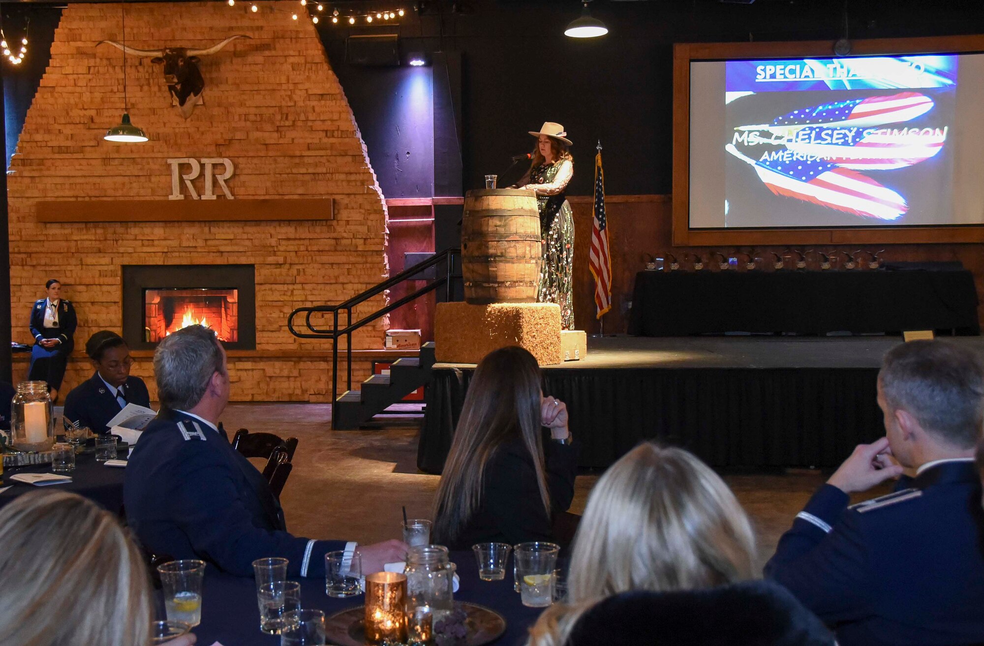 Chelsey Stimson, artist and owner of American Feathers, shares her story at the 301st Annual Awards Banquet Feb. 9, 2019 at River Ranch Stockyards, Fort Worth, Texas. After the passing of her husband, a Navy SEAL and former Marine, from an accident at home, Stimson started painting the American Feather to represent the service and sacrifice of those in the military.
(U.S. Air Force photo by MSgt. Jeremy Roman)