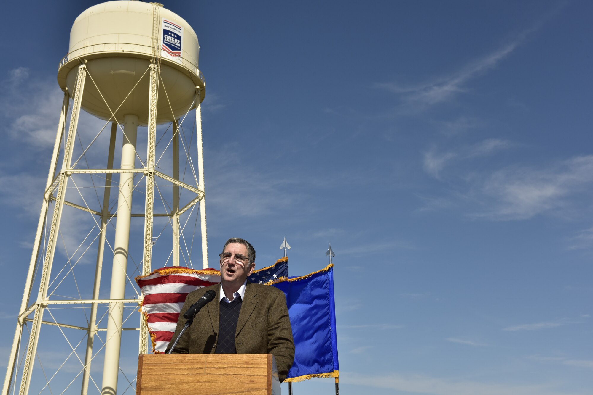 Tom Neubauer, Bay Defense Alliance president, talks about the relationship between the American Defense Community and the military community during an unveiling at Tyndall Air Force Base, Fla., Feb. 13, 2019. Tyndall was awarded the Great American Defense Community Award for 2019 with a commemorative logo painted on the water tower to represent Bay County’s accomplishments. Bay County is one of five communities across the country to be named a Great American Defense Community in 2019. (U.S. Air Force photo by Staff Sgt. Alexandre Montes)