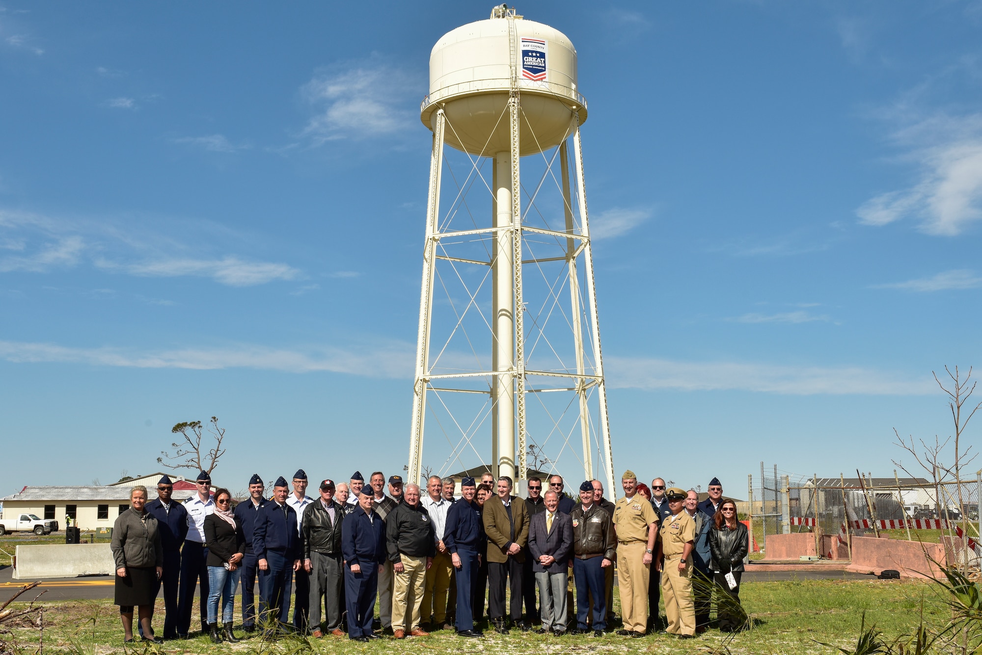 Members of the Great American Defense Community and Tyndall Air Force Base pose for a group photo during the unveiling of a logo on the installation’s water tower at Tyndall Air Force Base, Fla., Feb. 13, 2019. Tyndall was awarded the Great American Defense Community Award for 2019 with a commemorative logo painted on the water tower to represent Bay County’s accomplishments. Bay County is one of five communities across the country to be named a Great American Defense Community in 2019.  (U.S. Air Force photo by Staff Sgt. Alexandre Montes)