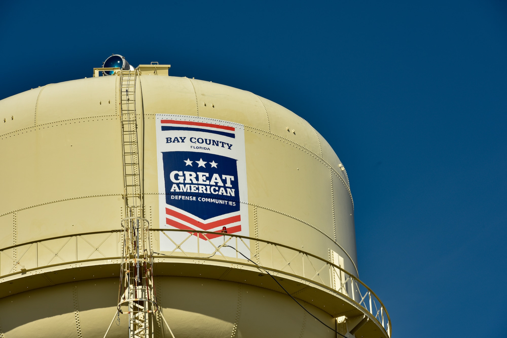 Tyndall Air Force Base’s water tower now wears a logo that signifies being awarded the 2019 Great American Defense Community Award during a ceremony at Tyndall Air Force Base, Fla., Feb. 13, 2019. The GADC program leaders work to recognize military communities and regions that help improve the quality of life for veterans, service members and their families. (U.S. Air Force photo by Staff Sgt. Alexandre Montes)