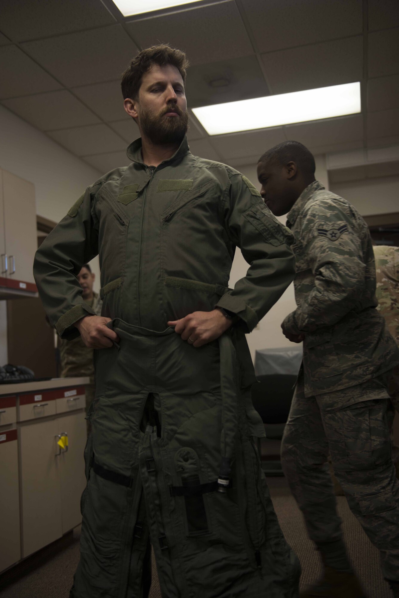 Jon Heder, actor, poses in a G-suit as Airmen help him strap up at Shaw Air Force Base, S.C., Feb. 8, 2019.