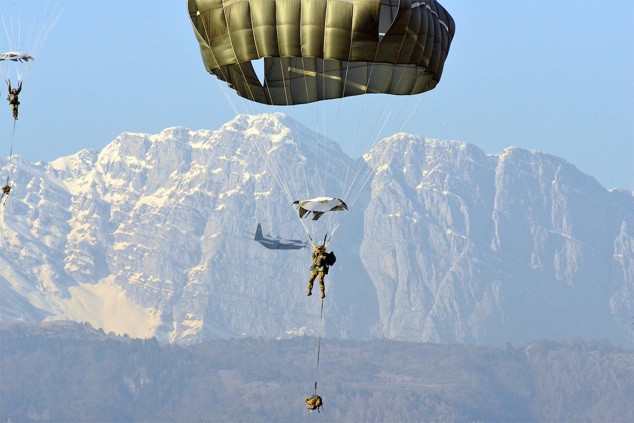 Army paratroopers descend.