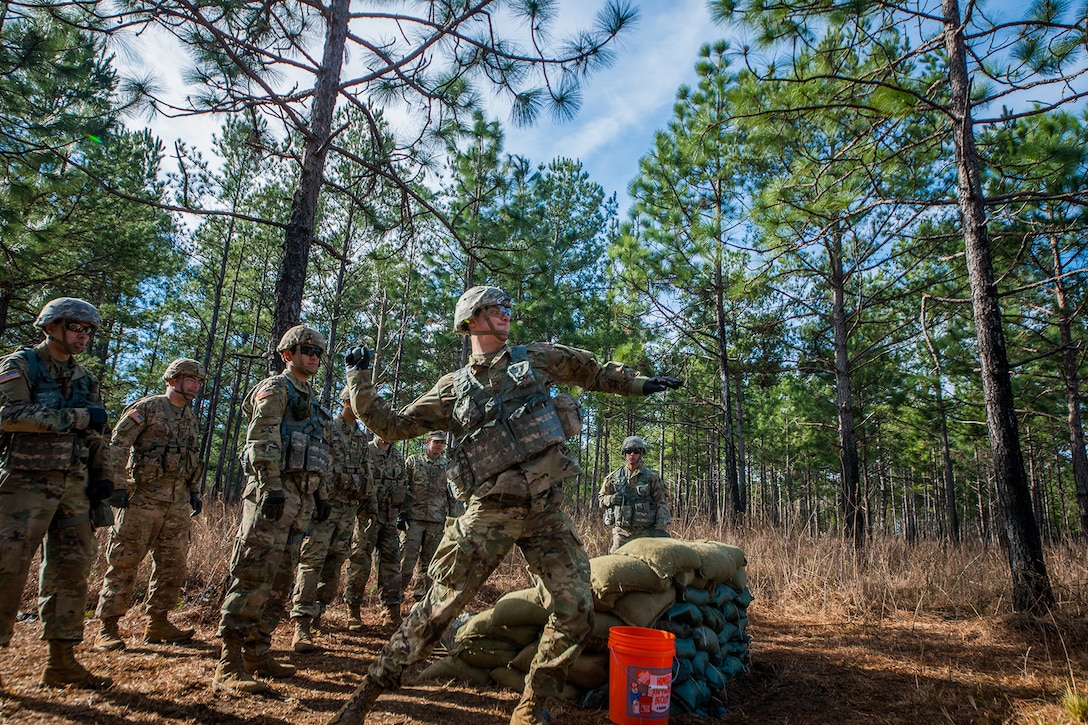 Soldiers train in the woods.