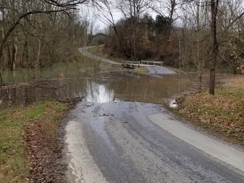 Water from Little Indian Creek covers River View Road in Jamestown, Ky., Feb. 14, 2019. Water discharging from Wolf Creek Dam on the Cumberland River at a rate of 30,600 cubic feet per second caused the creek to back up to the roadway. The U.S. Army Corps of Engineers Nashville District is working with the Louisville District, state and local officials to install a temporary flood wall to protect the roadway as Wolf Creek Dam prepares to increase discharges as soon as conditions allow. (USACE Photo)