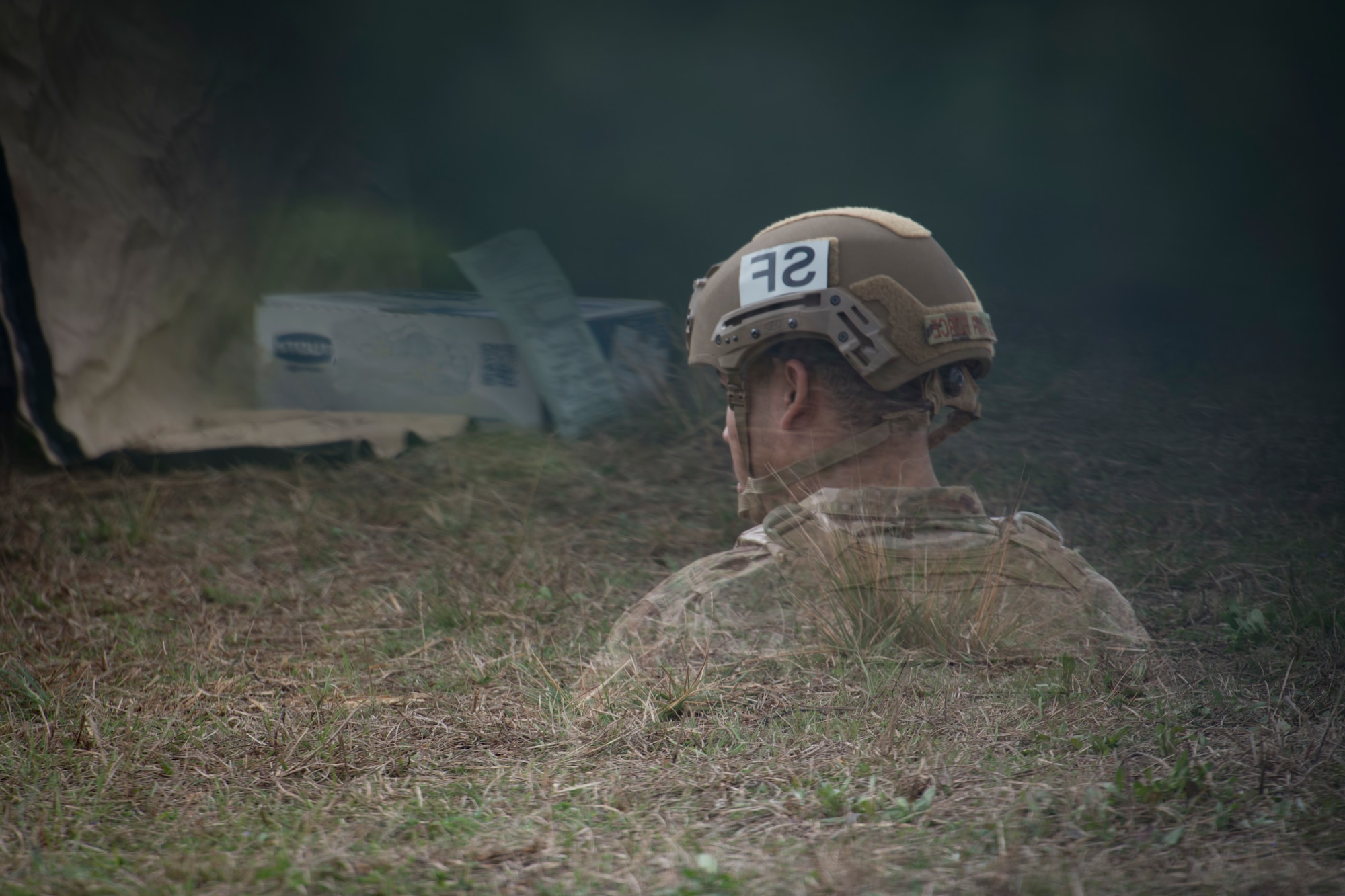 An Airman is reflected in a vehicle mirror while he heats up his MRE, (meal ready to eat), during Exercise Crescent Moon Feb. 12, 2019, at North Auxiliary Airfield in North, S.C.